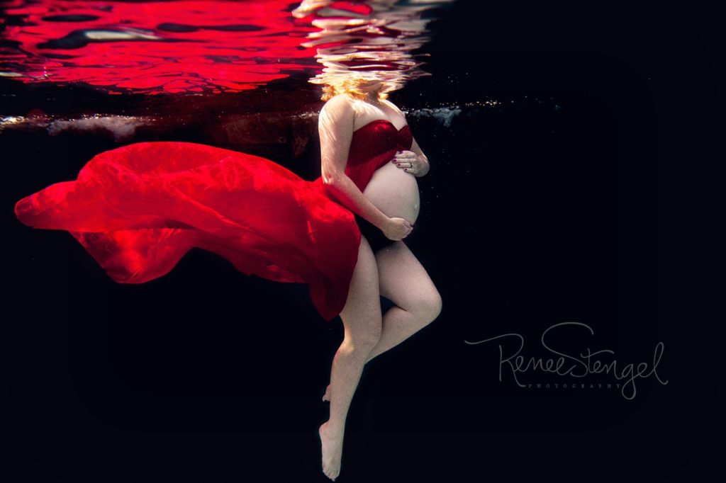 Underwater Maternity Fiery Red Dress in Deep End against Black Background