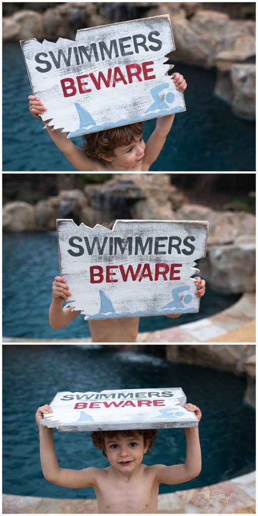 Rustic Avenue Co Wooden Swimmers Beware of Shark Sign held by little boy 