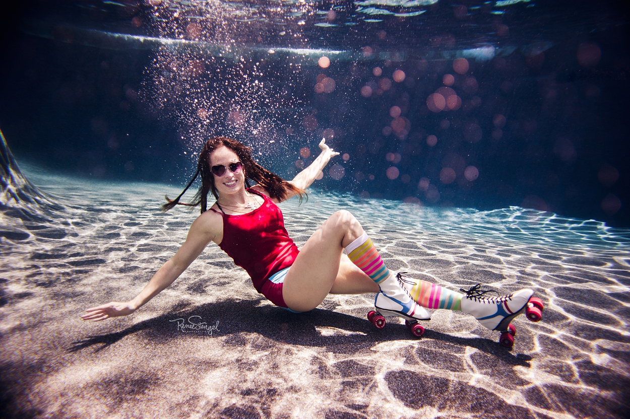 Charlotte Underwater Roller Derby Girl with Dreads and Rainbow Striped Socks