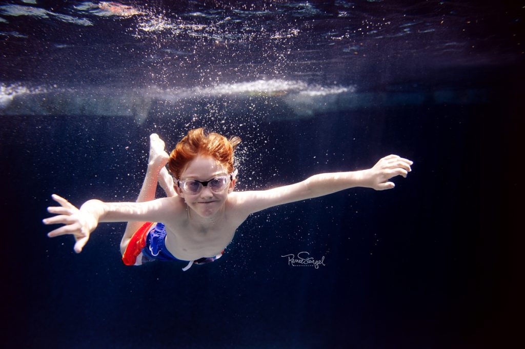 Redhead Boy Flying Underwater with Goggles by RENEE STENGEL Photography | Charlotte Portrait and Underwater Photographer |