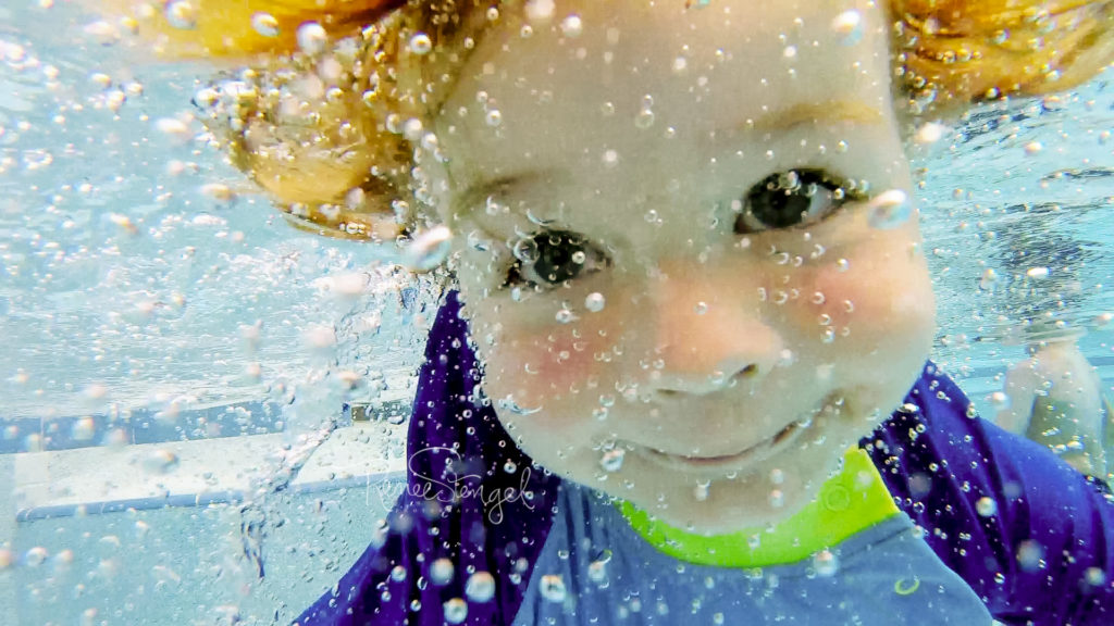 How I Got Started In UnderwaterPhotography screen shot from a GoPro Hero Session 5 video of Happy bright eyed baby Swimming Underwater