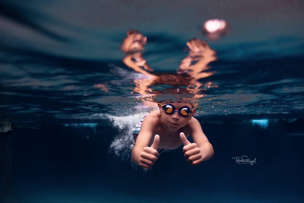 Boy swimming underwater in goggles in deep blue pool by RENEE STENGEL Photography | Charlotte Underwater and Portrait Photographer | 