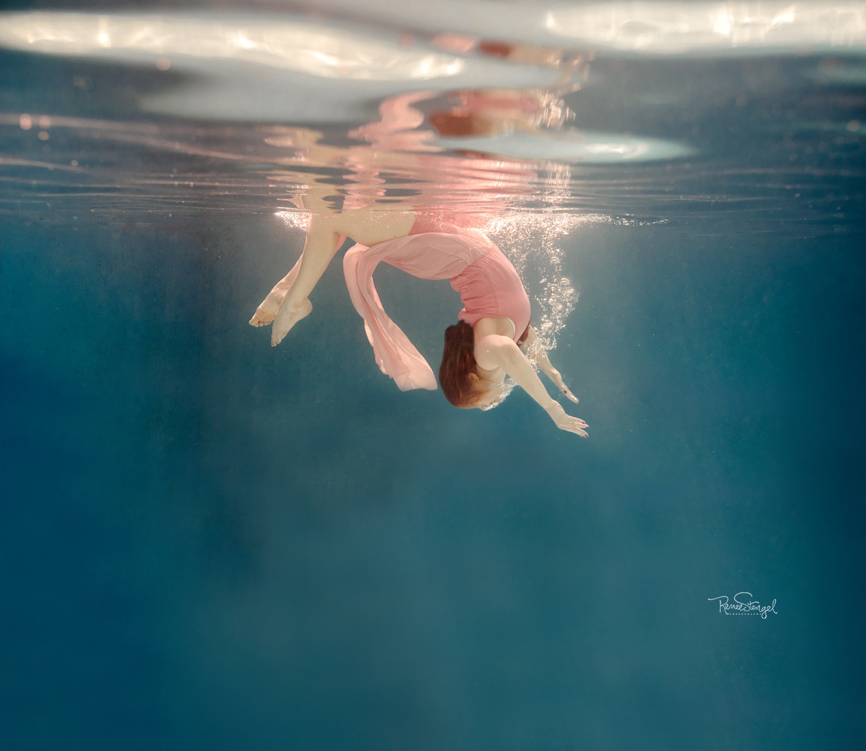 Underwater Yoga in deep tropical pool at Mhai Yoga in Havana Cuba with Beth of Women's Room Vermont