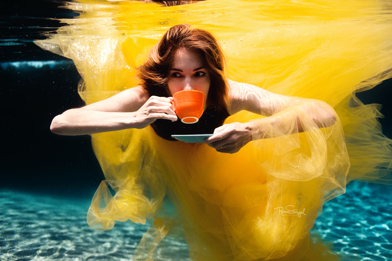 Woman Underwater in Yellow with Fiestaware Tea Cup in Orange and Teal