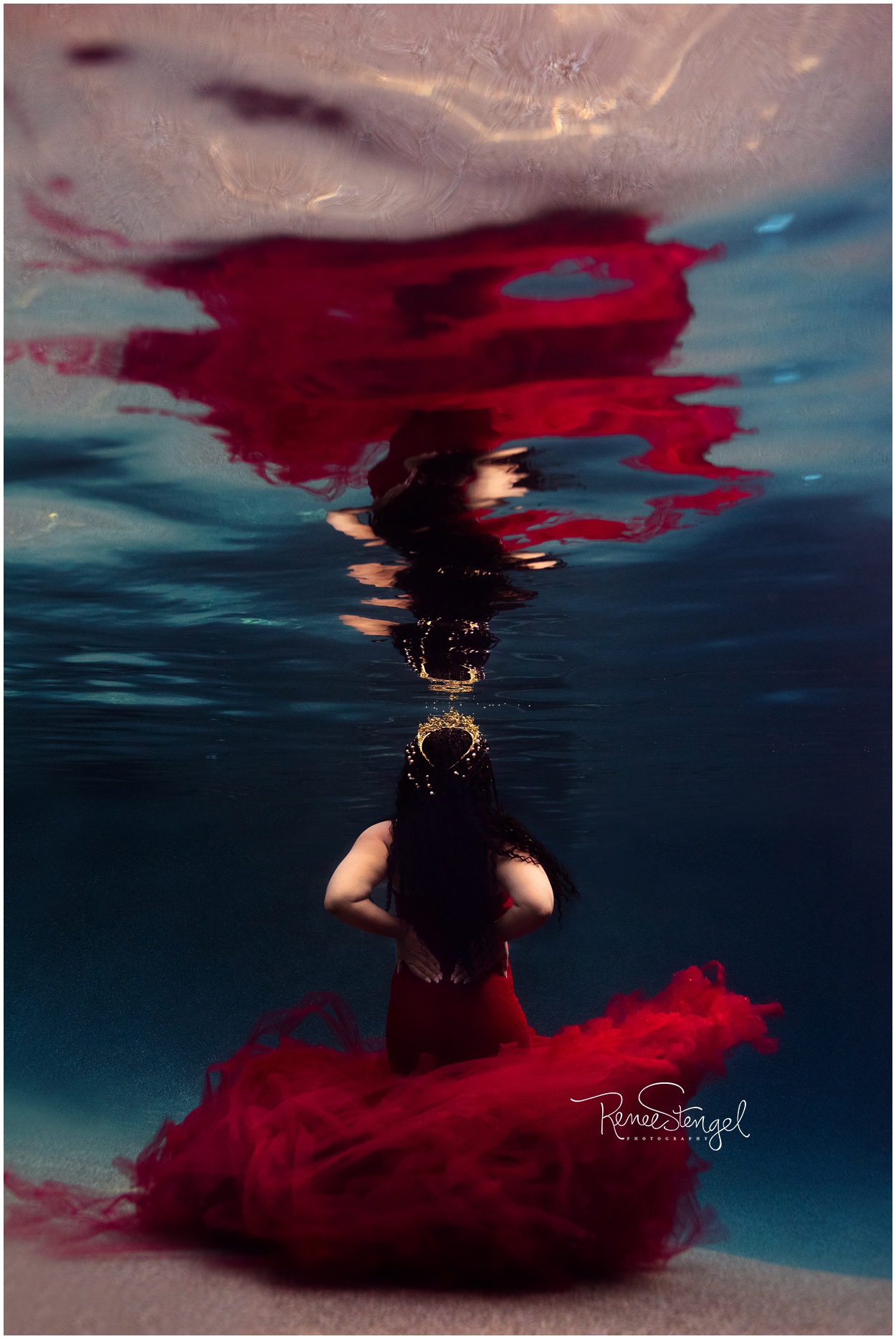 Underwater Maternity in Dramatic Sew Whimsey Tulle and Lace Red Gown with Pearl Hairpins and Gold Crown on braided black hair