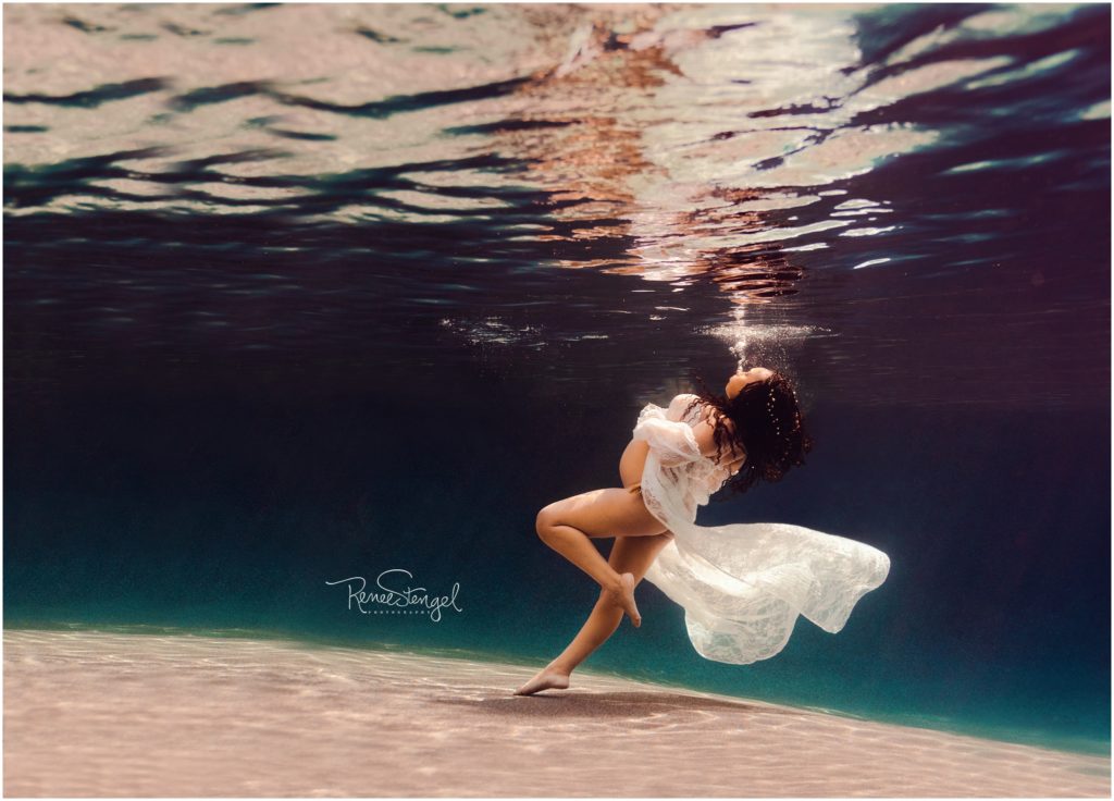 Unique Underwater Maternity Portrait of African American Woman in White Lace Gown