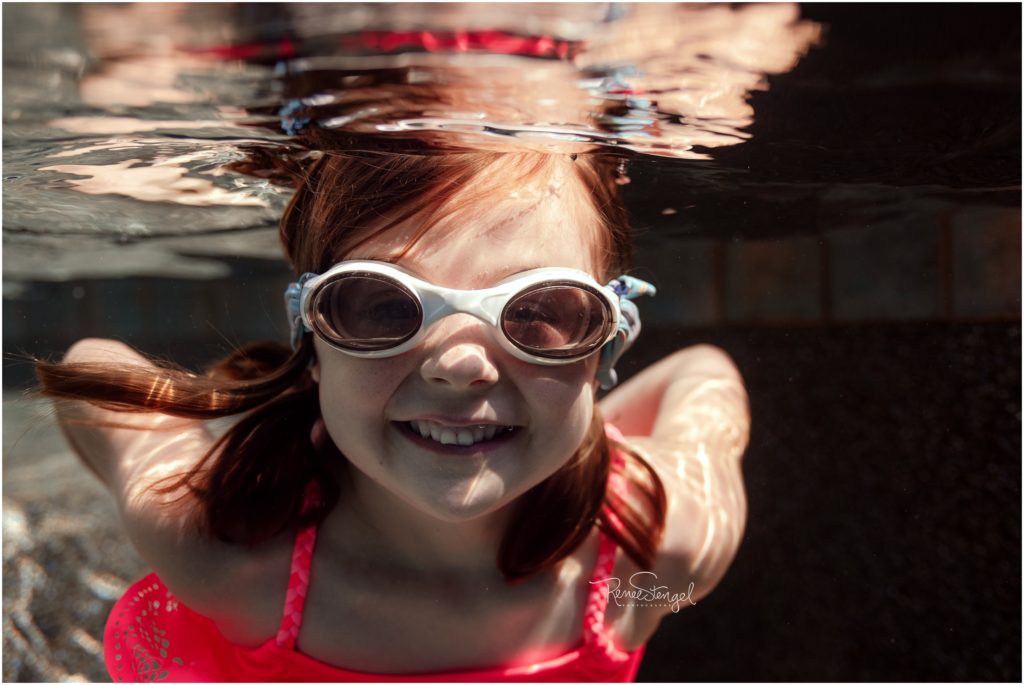Little Girl Underwater in Goggles during Maternity Photography Siblings Session in Charlotte NC