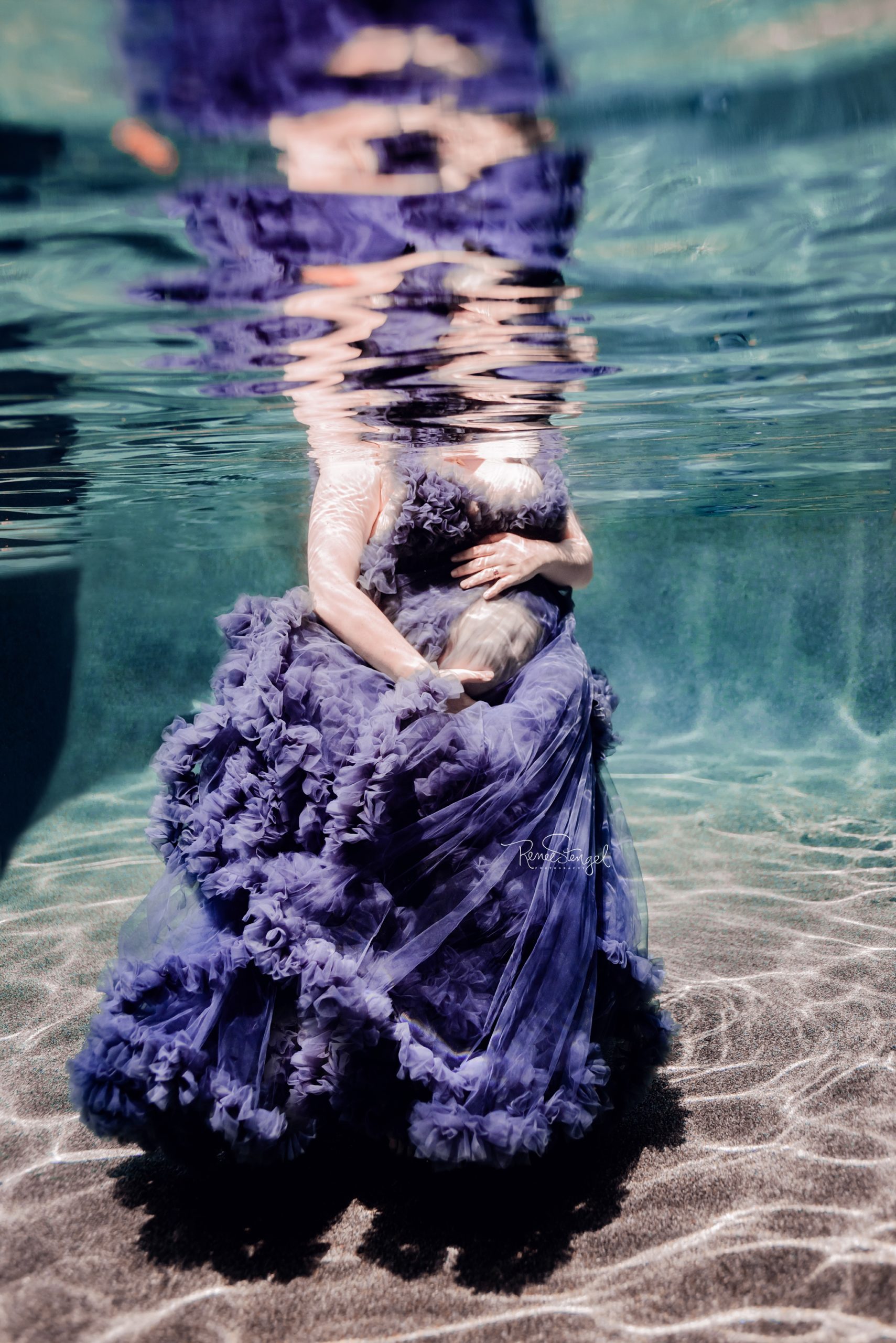 Underwater Maternity Photoshoot using purple couture tulle ruffled gown.