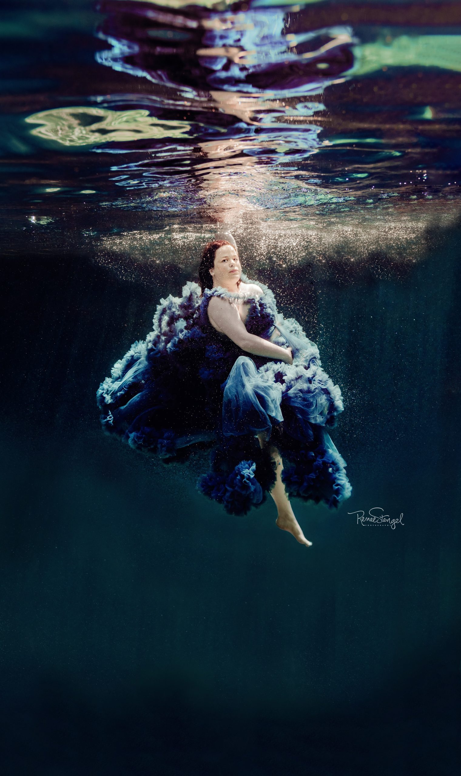 Underwater Maternity Photoshoot using purple couture tulle ruffled gown.